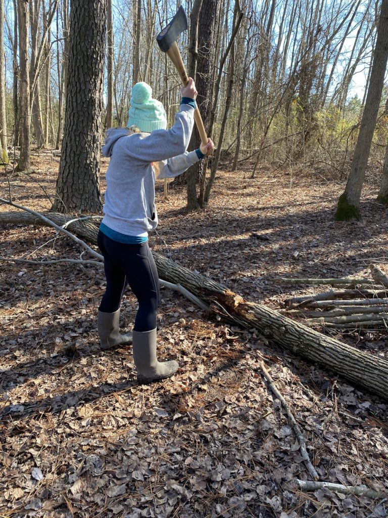 woman axe chopping wood nature